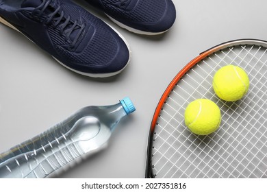 Sportive shoes, tennis racket and balls on light background - Powered by Shutterstock