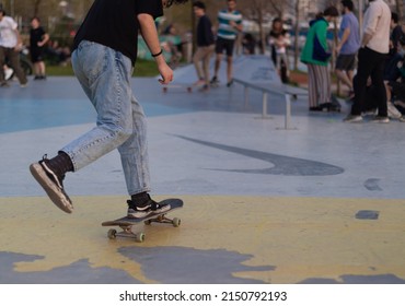 Sportive Teenager Riding Skate At Skatepark. Skateboarding. No People Face In Photo.