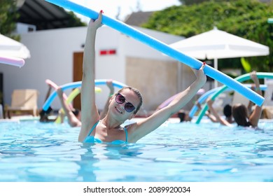 Sportive Woman Doing Exercises In The Pool, Water Aerobics