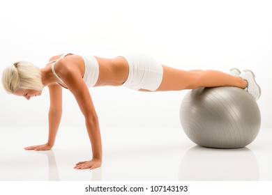 Sportive Woman Doing Pushup Exercise On Fitness Ball White Background