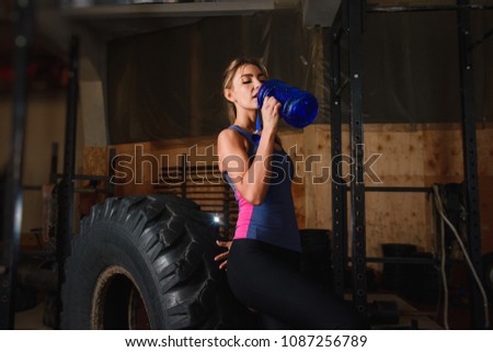 Sportive woman in gym drink water