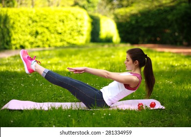 Sportive Young Woman Stretching, Doing Fitness Exercises In Green Park, Workout Outdoors