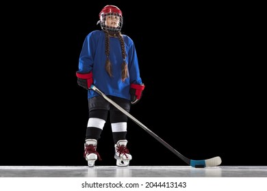 Sportive Youth. Portrait Of One Young Girl Professional Hockey Player In Blue Uniform Isolated Over Black Background. Maintaining Healthy Lifetyle. Concepth Of Childhood, Sport, Strength Ad