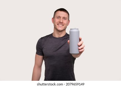 Sportman Showing Tin Can Drink. Energy Drink For Sport. Man With Can In Hands.