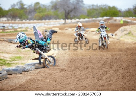 Sports, accident and man biker in a race on a dirt road in the desert with competition for hobby. Fitness, training and male athlete falling off bike and driving in a sand dune for adventure workout.