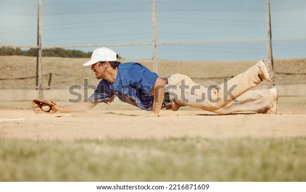 Sports, action and a man catching baseball,\
sliding in dust on floor with ball in baseball glove. Slide, dive\
and catch, baseball player on the ground during game, professional\
athlete on the field.