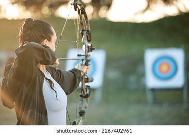 Sports archer, target and bow and arrow training for archery competition, athlete challenge or girl field practice. Shooting, objective and competitive woman focus on precision, aim or mock up - Powered by Shutterstock