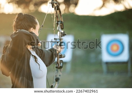 Sports archer, target and bow and arrow training for archery competition, athlete challenge or girl field practice. Shooting, objective and competitive woman focus on precision, aim or mock up