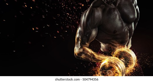 Sports background. Power athletic guy bodybuilder , execute exercise with dumbbells, in dark gym. Fire and energy