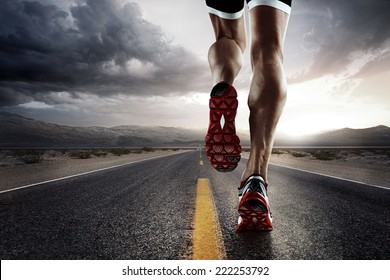 Sports background. Runner feet running on road closeup on shoe. 