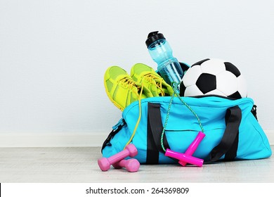 Sports bag with sports equipment in room - Powered by Shutterstock