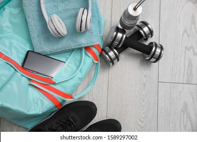 Sports Bag And Gym Stuff On Wooden Floor, Above View