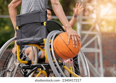 Sports ball, wheelchair basketball and hands of person playing match competition, challenge or attack on outdoor court. Player, commitment and back of athlete with disability, training and exercise - Powered by Shutterstock