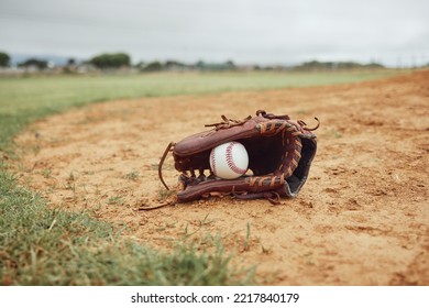 Sports, baseball gloves and field ball on dirt floor after game, competition or practice match for fitness, exercise or health. Softball pitch, training ground or baseball field equipment for workout - Powered by Shutterstock