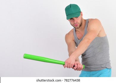Sports and baseball training concept. Guy in grey tank top holds bright green bat ready to hit. Player with concentrated face plays baseball. Man in cyan green cap on white background, copy space