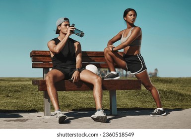 Sports, bench and fitness people with water bottle in a park for outdoor training, workout or wellness with blue sky mock up. Athlete or runner couple relax together after running with summer mockup - Powered by Shutterstock