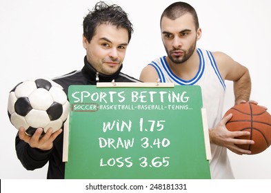 Sports Bets, Bookies, Football Player Holding Blackboard With Betting Odds,basketball Player In Background. Selective Focus On Guy In Foreground