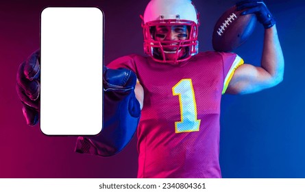 Sports Betting. American Football Player. Sports betting on futebol. Bets in the mobile phone application. Advertisement app. Man Showing At White Empty Smartphone Screen. Cellphone Display Mock Up