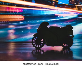 A Sports Bike Standing Beside A Busy Night Road