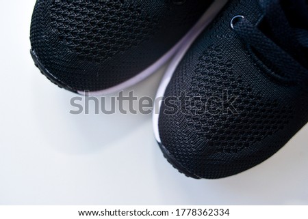 Sports black shoes and watches for monitoring your health on a white background