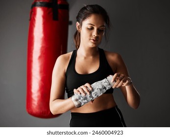 Sports, boxer or woman drinking water on break in boxing training, exercise or workout in gym studio. Punching bag, tired athlete or exhausted girl with fatigue, fitness or bottle on grey background - Powered by Shutterstock