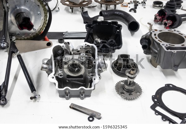 Sports car engine parts on the table. Assembling\
of vehicle engine. Car engine parts. Assembly of modern powerful\
car engine.