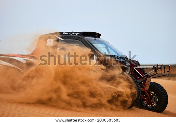Sports car gets over the difficult part of the\
route during the Rally raid THE GOLD OF KAGAN-2021. 26.04.2021\
Astrakhan, Russia