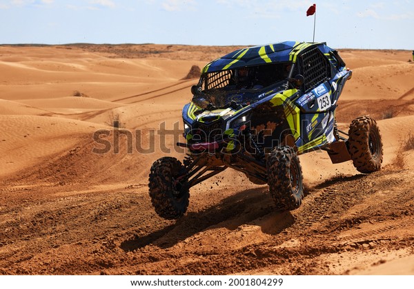 Sports car gets over the difficult part of the\
route during the Rally raid THE GOLD OF KAGAN-2021. 26.04.2021\
Astrakhan, Russia