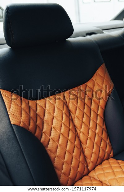 Sports car\
interior with black and orange\
leather