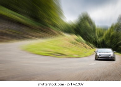 Sports Car Racing A Winding Road With Sharp Curve Up The Mountain