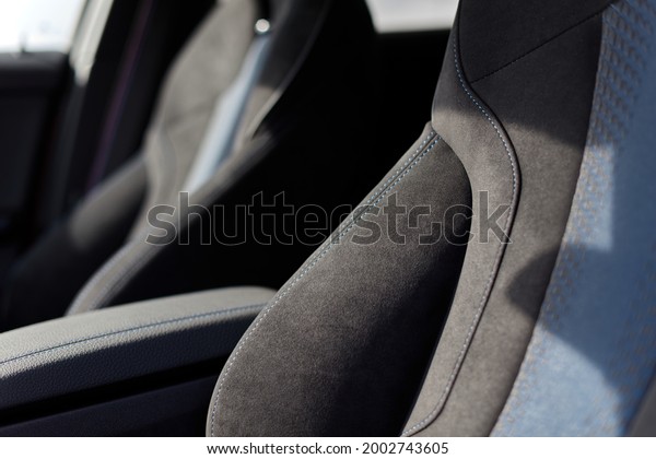 Sports car seats in graphite\
blue suede fabric. Close-up showing the texture of the\
material.