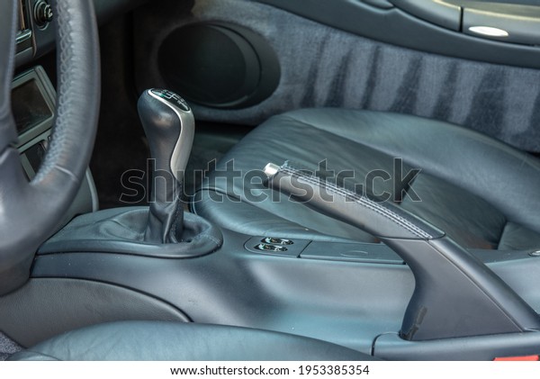 Sports car stick shift 6\
speed lever located in center console of luxurious interior of\
vehicle.