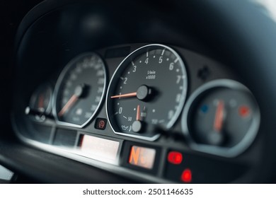 Sports car tachometer and dashboard with backlight. Close-up view of the modern car dashboard. Arrow of speedometer of supercar 