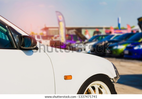 sports car and Used cars, parked in the parking\
lot of Dealership waiting to be sold and delivered to customers and\
waiting for the auction with the trading concept and auction in\
Automotive Industry