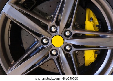 Sports car wheel with carbon ceramic disc and yellow brake caliper