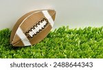 sports and competition paper origami concept of an American college high school junior striped or NFL football pigskin isolated on white background with copy space