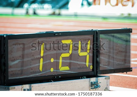 Sports Digital sport chronometer in sport event next to athletic stadium tracks
