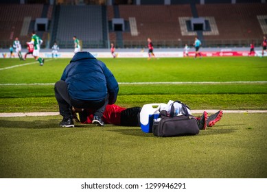 A sports doctor cares for the football player. - Powered by Shutterstock