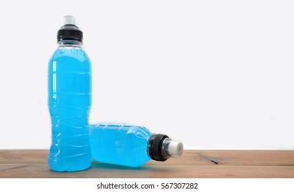 sports drink on wooden table and white background