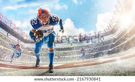 Sports emotions. American football in a large open stadium. Young agile american football player running fast towards goal line. Touchdown. Fans
