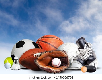 Sports Equipment, Rackets And Balls For All Seasons With Blue Sky Background And Copy Space.