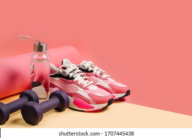 Sports Equipment And Sneakers On A Yellow 
Background. Sport Shoes,  Yoga Mat And Dumbbell. Healthy Lifestyle. Home  Workout.