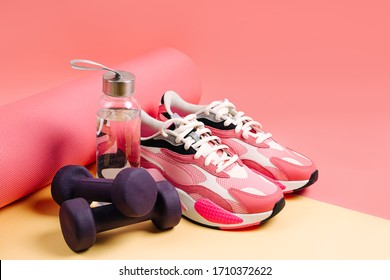 Sports Equipment And Sneakers On A Yellow 
Background. Sport Shoes,  Yoga Mat And Dumbbell. Healthy Lifestyle. Home  Workout.