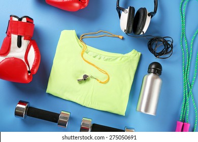 Sports Equipment And T-shirt On Color Table, Top View