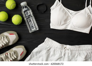 Sports Equipment And Wear On Dark Wooden Background, Top View