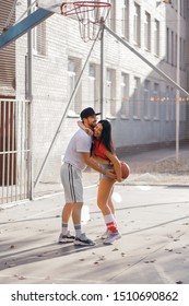 A Sports Family Plays Basketball, Young Parents And Their Daughter Spend Free Time On The Basketball Court, Lead A Healthy Lifestyle, A Man And A Woman Fool Around, Pick Up The Ball