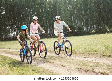 Sports family riding bicycles. Father, mother and son with bikes - Shutterstock ID 1655863858