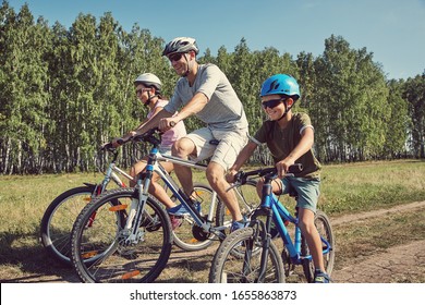 Sports family riding bicycles. Father, mother and son with bikes - Shutterstock ID 1655863873