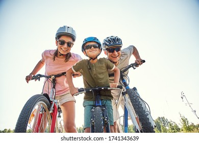 Sports family riding bicycles. Father, mother and son with bikes - Shutterstock ID 1741343639