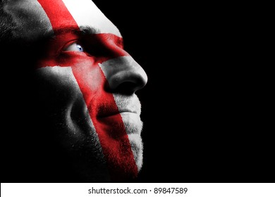 Sports fan - a patriot. On the painted colors of the flag of his country on his face.